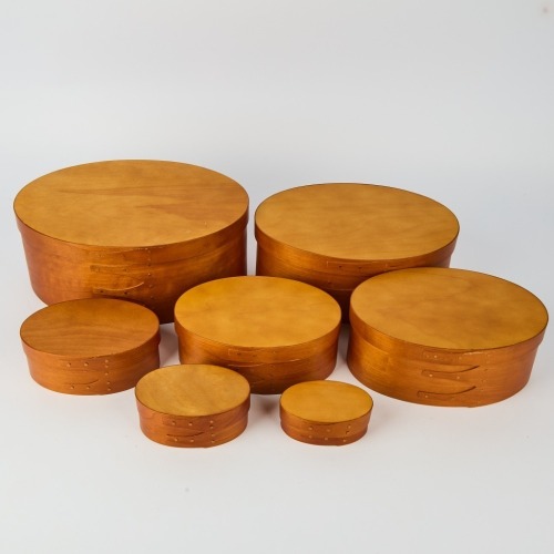 A stack of seven Bentwood Shaker Maple Boxes with swallow-tail joint construction