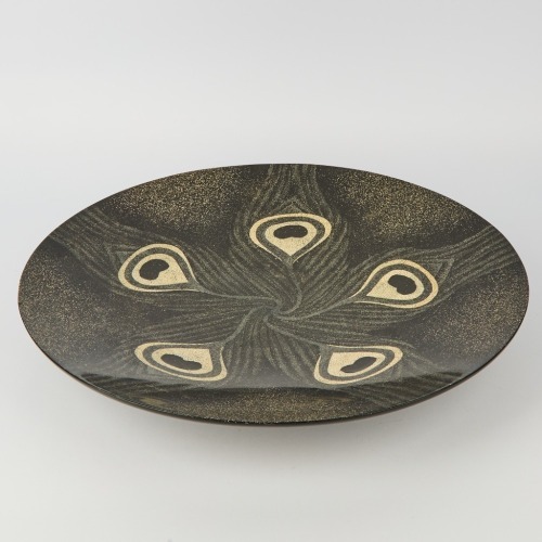 A Very Large Black Peacock Platter