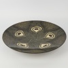 A Very Large Black Peacock Platter