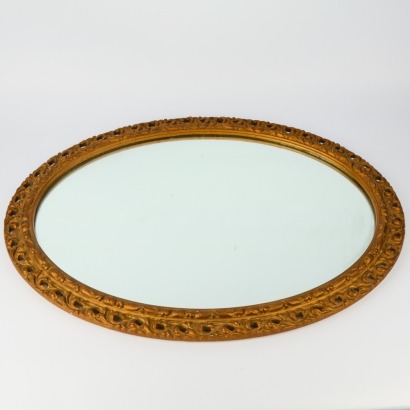 An Oval Ornate Cast Framed Wall Mirror