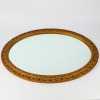 An Oval Ornate Cast Framed Wall Mirror