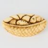 A Hand-Carved Bone Fish in Basket Miniature Sculpture