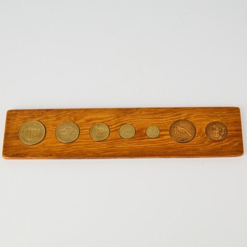 A Set of Coins of Aotearoa Embeded in Wood