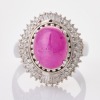 Platinum, 4.61ct Ruby Cabochon / 0.50ct Round / 0.19ct Baguette Diamond Cluster Ring
