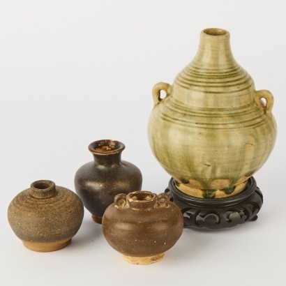 A Group of Three South Asian Brown Glazed Jars AND A Celadon Handled Bottle, Cracked