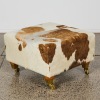 A Cowhide Cube Ottoman On Brass Castors - 2