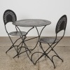 A Vintage Folding Wrought Iron French Bistro Setting