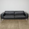 A Black Leather Couch and Ottoman - 3