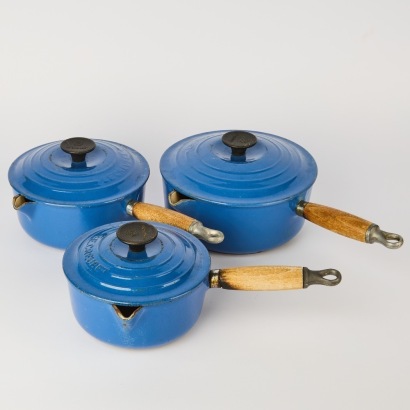 A Set of Three Le Creuset Saucepans with Lids