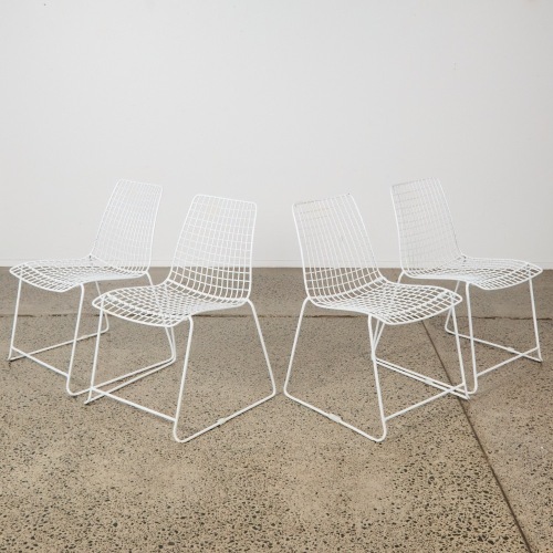 A Set of Four Wire Stackable Chairs