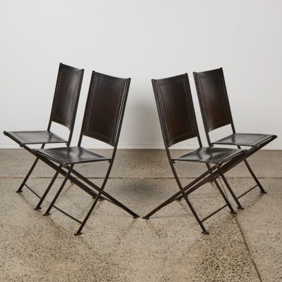 A Set of Four French Leather and Iron Folding Chairs
