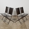A Set of Four French Leather and Iron Folding Chairs