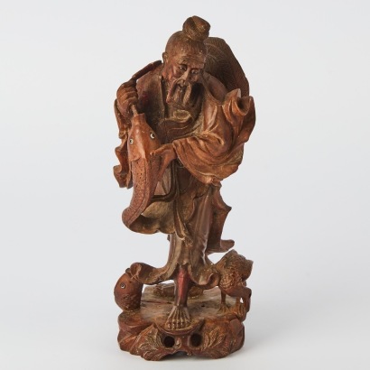 An Oriental Carved Fisherman