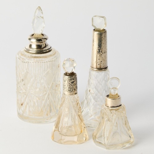 A Set of Four Antique Sterling Silver Perfume Bottles with British Hallmarks