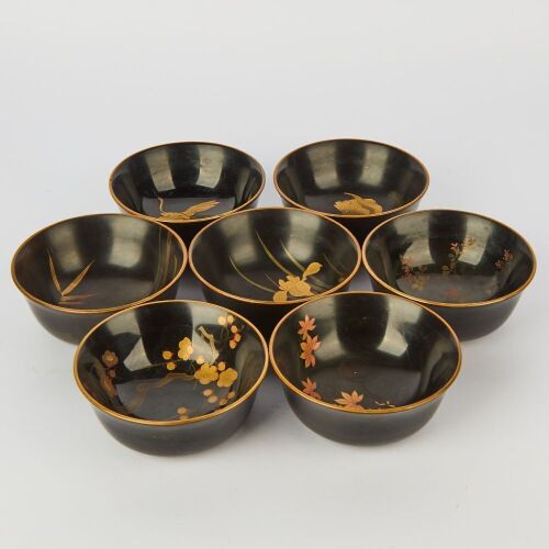A Group of Seven Japanese Early to Mid 20 Century Black Lacquer Gilt Floral Bowls