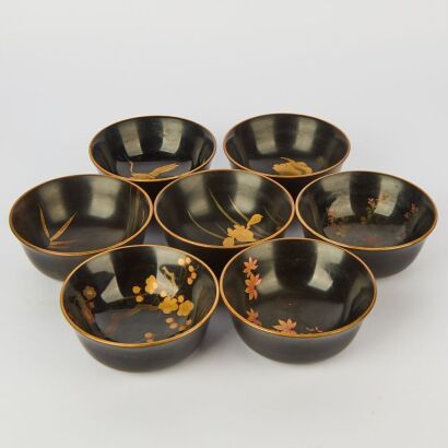 A Group of Seven Japanese Early to Mid 20 Century Black Lacquer Gilt Floral Bowls