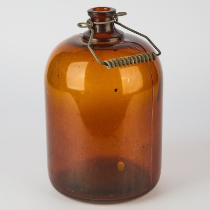 A Vintage Amber Glass Cider Bottle with Wire Bail Handle