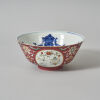 A Chinese Red Ground Famille Rose Medallion Bowl (Da Qing Qianlong Nian Zhi Mark)