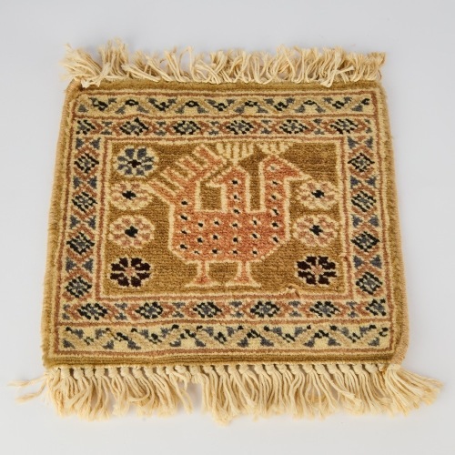 A Small Rug Depicting a Bird