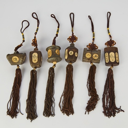 A Group of Six Chinese 20th Century Carved Wood Small Pendants