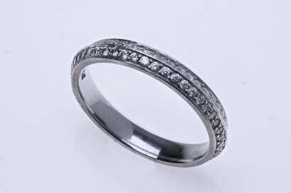 A diamond band ring, bead set double full circle of round cut diamonds, estimated total diamond weight 0.46 carat. Platinum. Weight 3.0 grams. Size J.