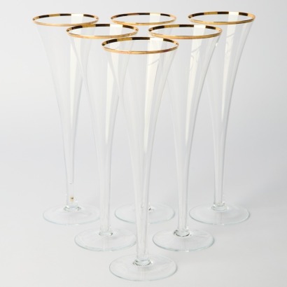A set of six tall hollow stemmed crystal champagne flutes with gold rim