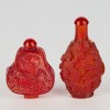 A Set of Two Chinese Red Glass Carved Snuff Bottles