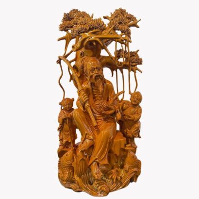 A Chinese Carved Torreya Wood Figure of an Old Fisherman