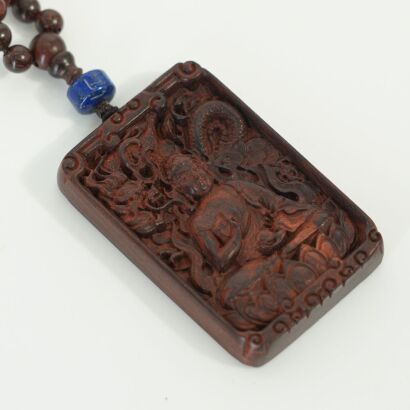A Chinese 20th Century Carved Hardwood Guanyin Pendant