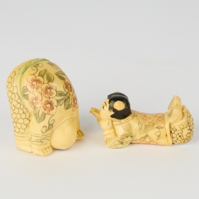 A Pair of Resin Carved Boy Figurines