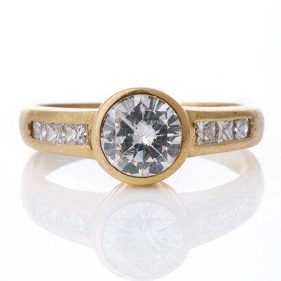 18ct Yellow Gold, 1.09ct Round Brilliant Cut / 0.37ct Princess Cut Diamond Accented Ring