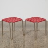A Pair of Red Woven Vinyl Stools