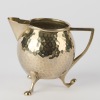A Hammered Metal Milk Jug