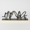 A Metal Sculpture Jumping Through Hoops