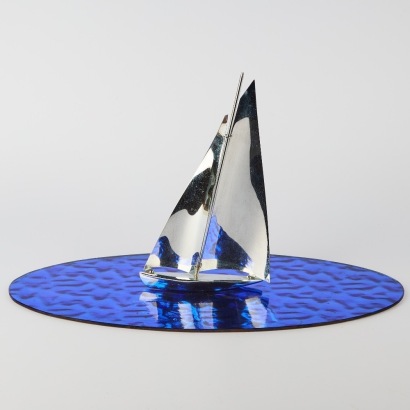 An Art Deco Metal Yacht on Glass