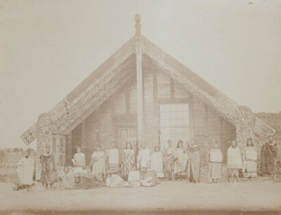 UNKNOWN PHOTOGRAPHER Figures standing in front of a marae