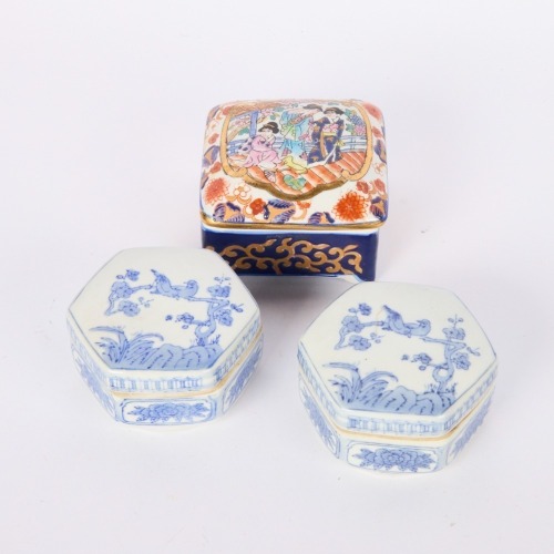 A Set of Three Chinese Famille Rose and Blue and White Lidded Boxes