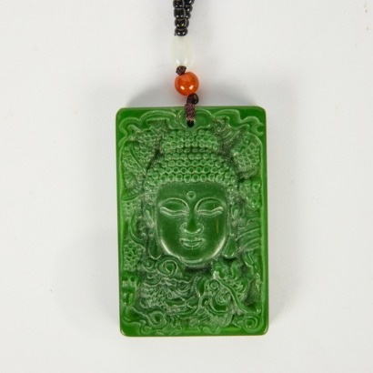A Chinese Carved Green Jade Buddha Head Pendant