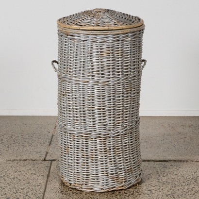 A Tall Wicker Laundry Hamper with Lid