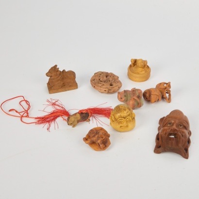 A Group of Nine 20 Century Chinese Carved Wood Animal and Figural Ornaments