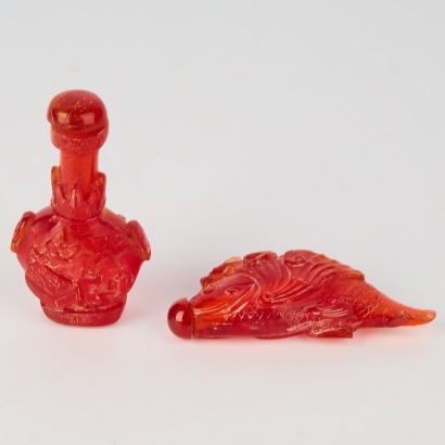 A Set of Two Chinese 20th Century Carved Red Resin Snuff Bottles