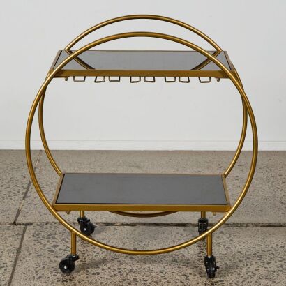 A Bar Cart with Black Glass Shelves in Gold Finish
