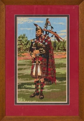A Large Framed Needlepoint of a Scottish Bagpipe Player