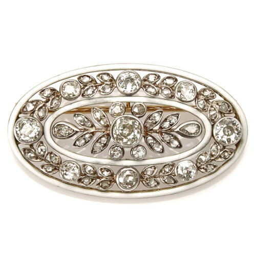 A Victorian diamond and enamel oval brooch, bezel set old European cut centre diamond of estimated weight 0.60 carat, surrounded by sixty-two old European and mix cut diamonds of estimated total weight 3.0 carats, in ornate garland style. 18ct white gold.