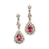 A pair of ruby and diamond cluster drop earrings, the articulated drop earrings are comprised of two claw set pear cut rubies of estimated total weight 1.60 carats, surrounded and accented by thirty single and round brilliant cut diamonds of estimated tot