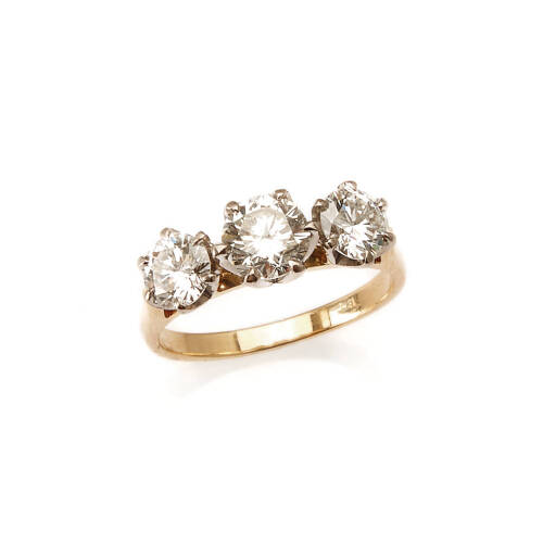 A three stone diamond ring, claw set round brilliant cut diamond centre of estimated weight 0.70 carat, set either side with round brilliant cut diamonds of estimated total weight 0.92 carats. 18ct yellow and white gold. Weight 3.7 grams. Ring size J. Gem