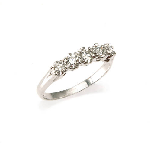 A diamond band ring, five graduating claw set round brilliant cut diamonds of estimated total weight 0.59 carats. 18ct white gold. Weight 3.0 grams. Ring size M.
