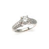 A 1.00 carat diamond ring, claw set round brilliant cut diamond centre of estimated weight 1.00 carats, 'G' colour and 'SI2' clarity, with sixty-eight pave set round brilliant cut diamonds on the shoulders. 18ct white gold. Weight 5.2 grams. Ring size L. 