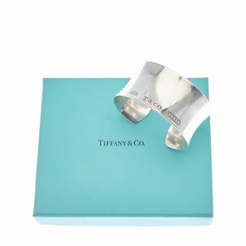 An 1837 wide cuff, Tiffany & Co. Concave cuff stamped '1837' 'T&CO' '925'. Sterling silver. Weight 64.2 grams. Width 3cm. Inside diameter 6cm. Original pouch and box.