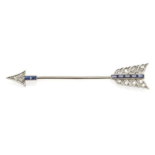 An Art Deco sapphire and diamond arrow jabot-pin, thirteen old single cut diamonds of estimated total weight 0.25 carats, accented with seven baguette cut sapphires of estimated total weight 0.42 carats. Platinum and 18ct gold. Weight 2.5 grams. Length 57